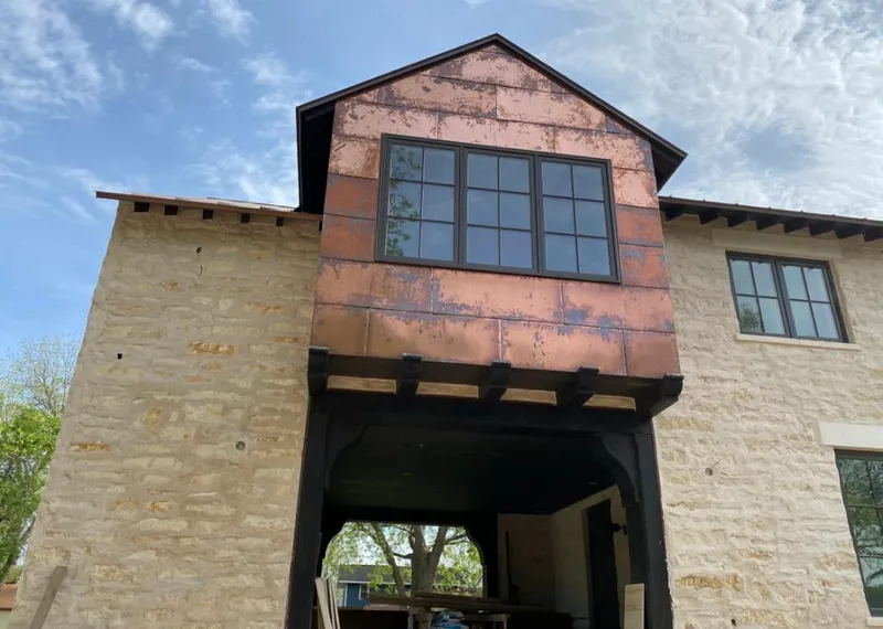 Copper metal panel facade on a stone building for Skylight Installation in Jordan
