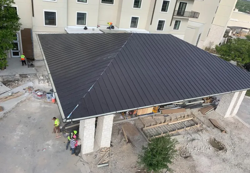 Metal roofing installation team working on a commercial building in Jordan